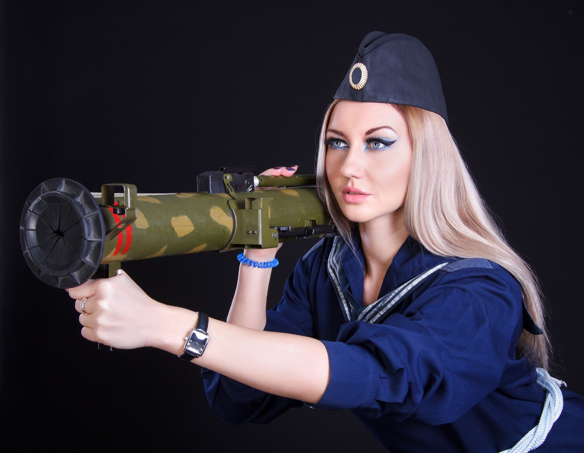Beautiful young woman in a marine uniform with a grenade launcher