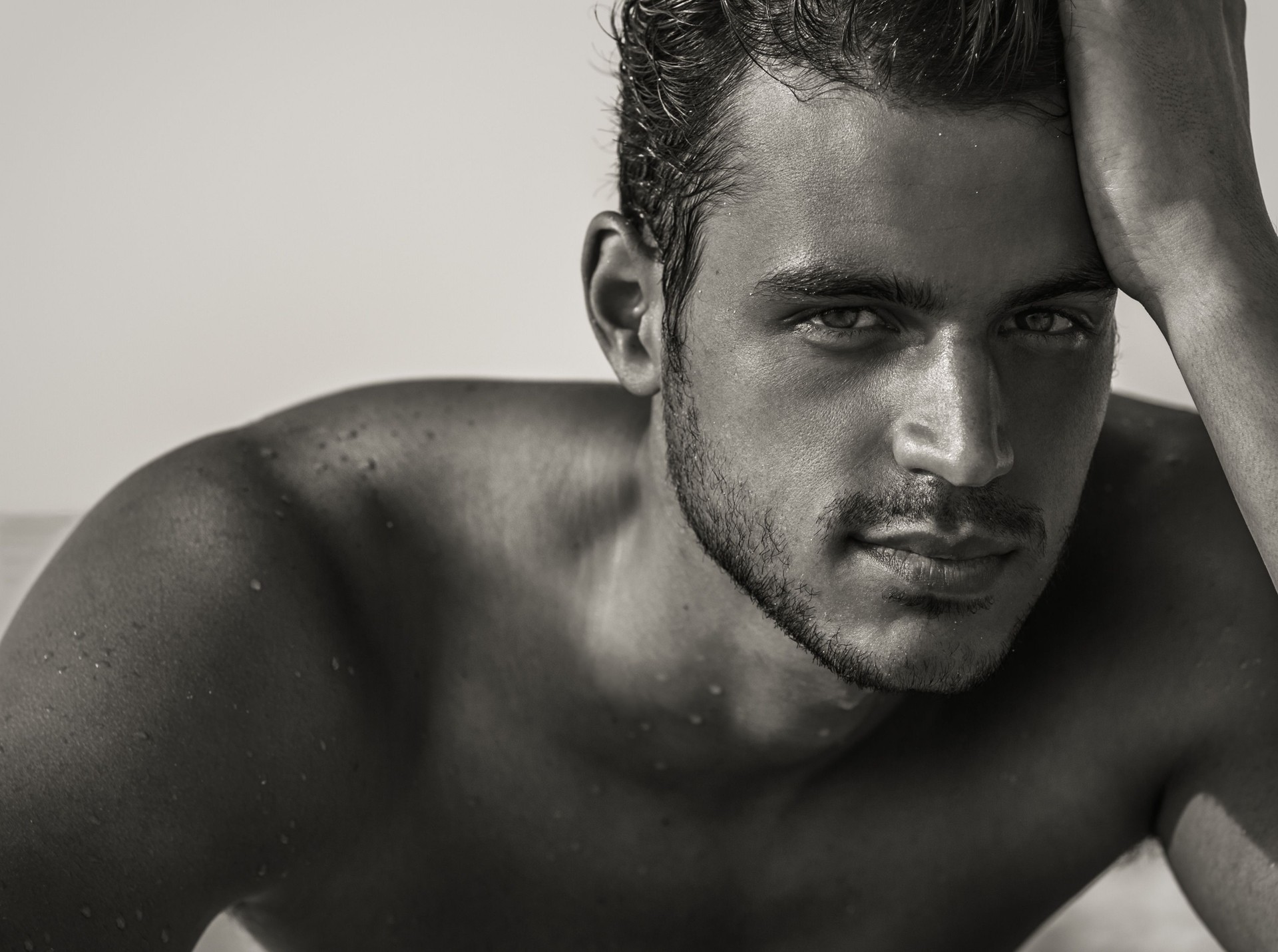 Sexy handsome male model with beautiful eyes staring into the camera. Man beauty portrait.